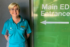 Lady standing next to an ED sign