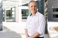 Dr Andrew Redfern stands outside a building