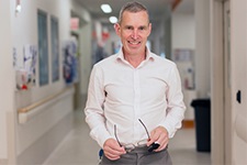 Laurens Manning stands in a hospital corridor