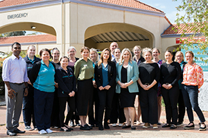 Members of the Peel Health Campus transition and commissioning team stand outside the hospital's emergency department.