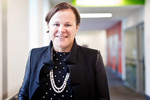 Professor Fiona Wood stands in a corridor