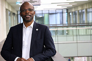 Dr Koya Ayonrinde stands in a corridor inside Fiona Stanley Hospital.
