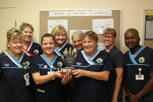 A group of Murray District Hospital staff accept an award for achieving well above the hand hygiene compliance rate