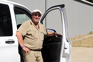 A man leans against a car