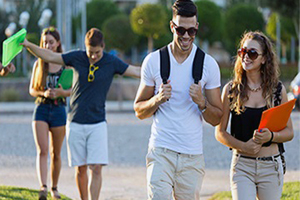 A group of young adults walking in a park
