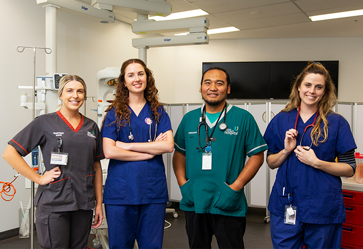 One male and three female health professionals in a treatment area