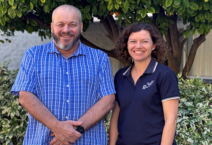 Andrew Rowling stands beside Senior Physiotherapist Nikki Strahan in a garden