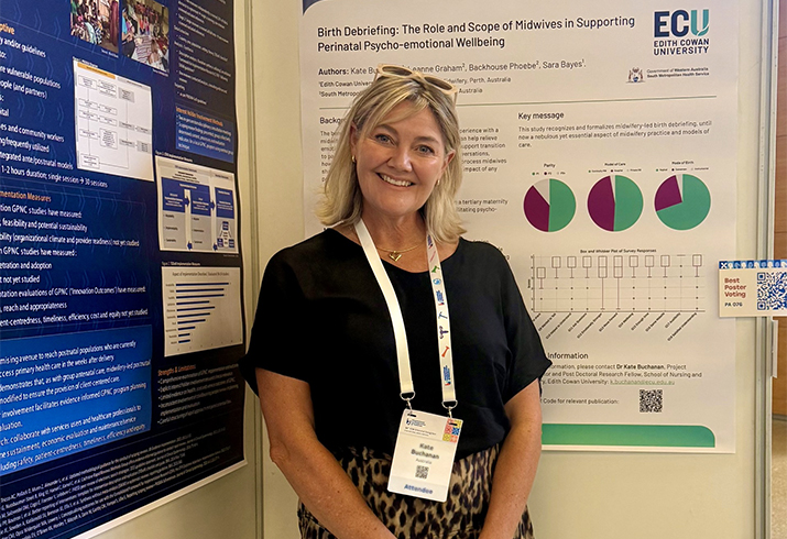 Kate standing in front of her conference poster