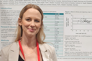 Kathryn Watson stands in front of a scientific poster.