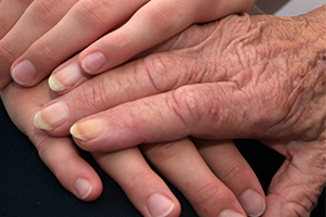 Three hands overlaying each other